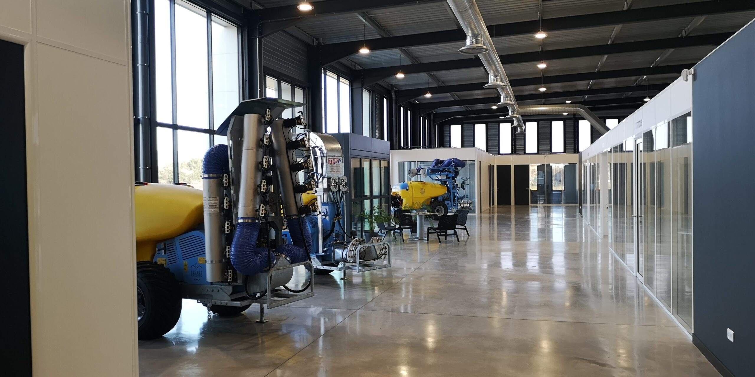 Exposition de pulvérisateurs dans le hall des Établissements Chabas à Charleval